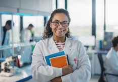 woman in lab holding books
